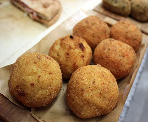 Freshly fried handmade arancini, ready to serve